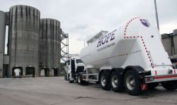 Hope Construction Materials presents a newly-liveried Feldbinder silo truck next to its truck distribution silos.