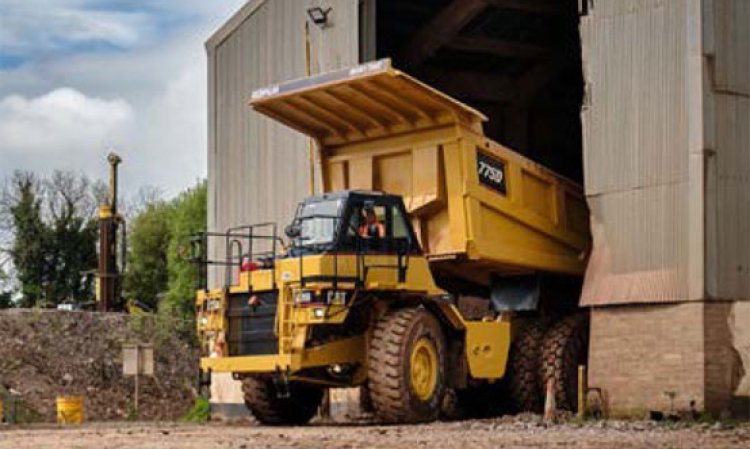 One of the plant’s CAT 775D haul trucks unloads limestone into the crusher.