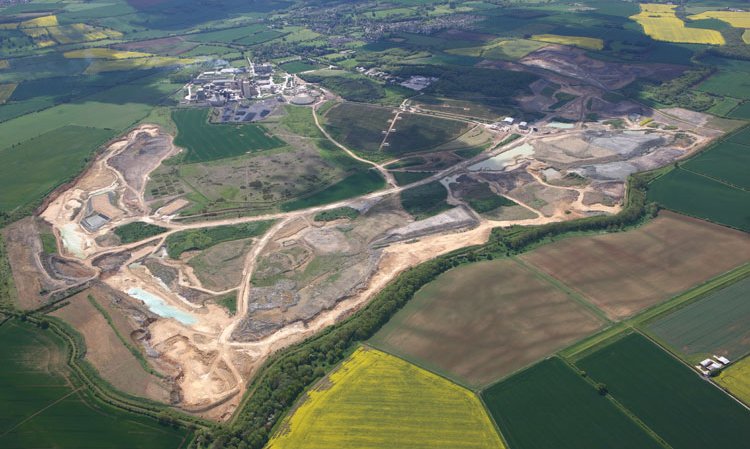 View over the plant’s extensive quarry with plant in the background and solar farm (ringed) in the centre.