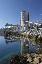 The Norcem Kjopsvik plant is located on a thin strip of land between mountains and the Tysfjord in Nordland, Norway.
