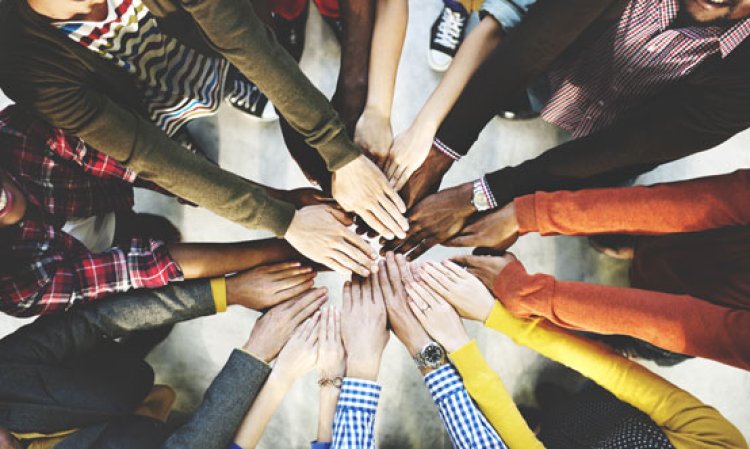 Group of diverse hands together joining concept. Source: Shutterstock.
