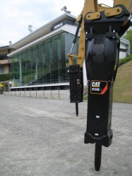 Caterpillar Japan's  demonstration centre at Chichibu provides spectators with an all-weather pavilion from which they can watch machine demonstrations (background). H130 E series  hammer (foreground).