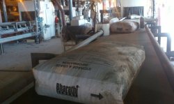 The first bag of cement produced at the Vicat Sagar Cement plant comes off the production line.