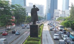 The statue of General Sudirman salutes Sudirman Road, Central Jakarta, Indonesia. Sudirman was a key figure in Indonesia's battle for independence with the Netherlands in the 1940s.